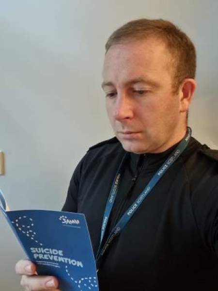 PC Johnathan Davis with the suicide prevention materials.