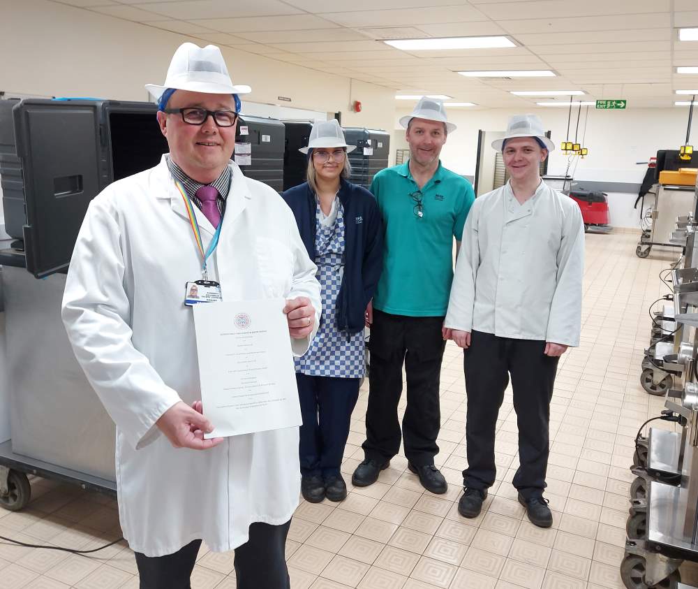 L-R: Ruaraidh McKinnon, Caitlin Angus (cook), Steven Tait (team leader), and Bradley Gillespie (cook) in the production kitchen at Royal Cornhill Hospital