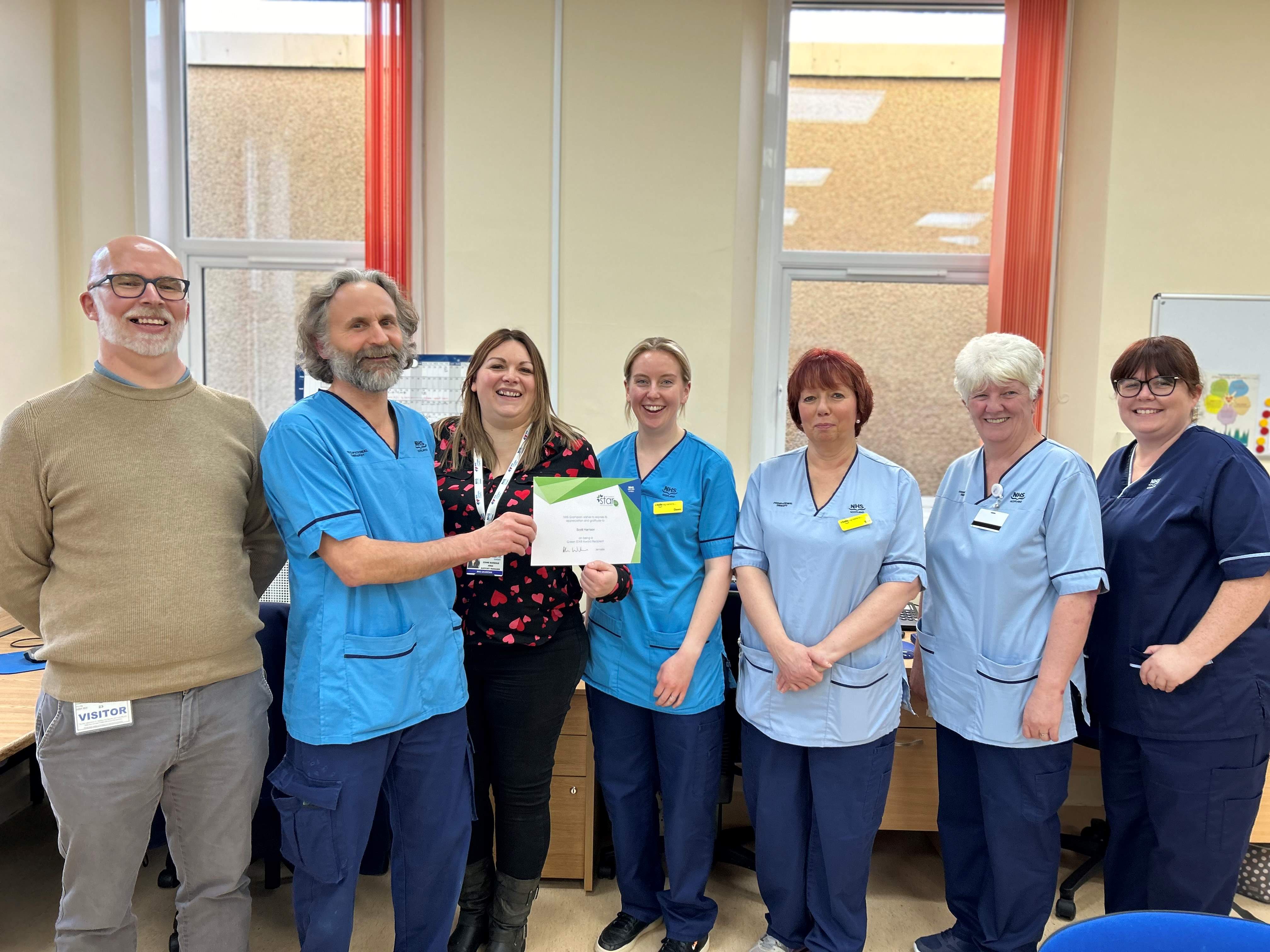 Scott Harrison and his team alongside Neil Duncan at Jubilee Hospital, Huntly.