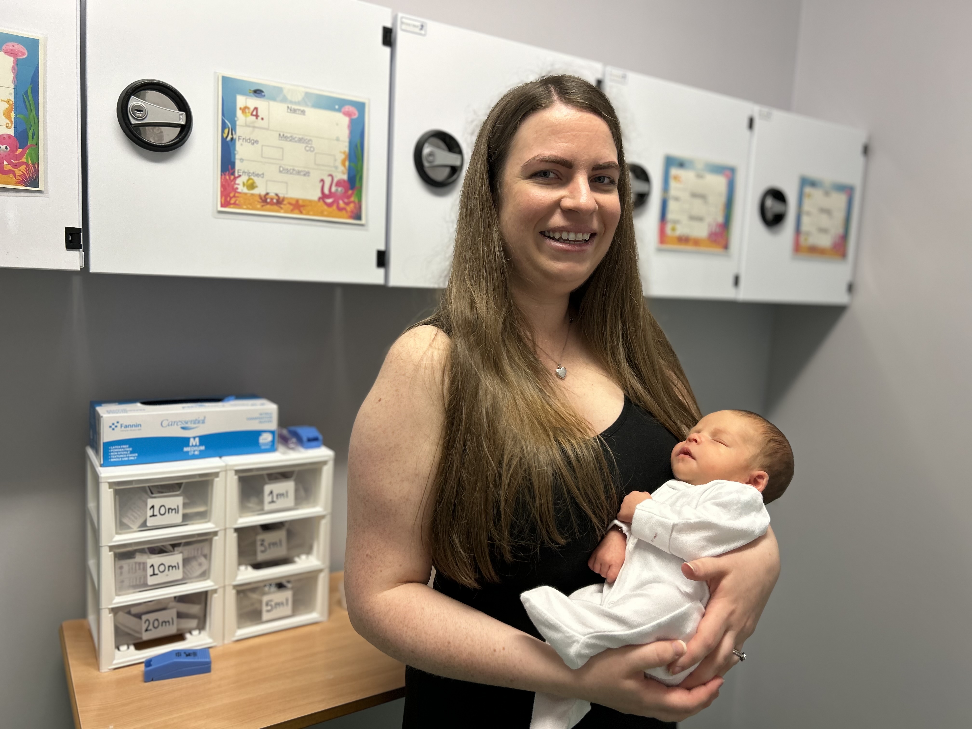 Abby and her new arrival, little Oliver, at the new medicine preparation station in the infant medical ward at Royal Aberdeen Children’s Hospital.