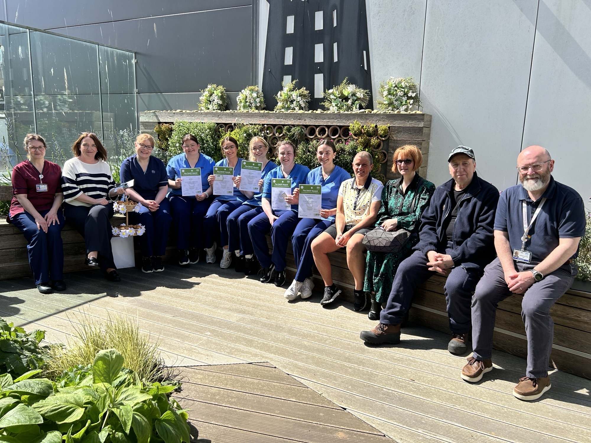 left to right: Denise Johnson, June Barnard, Louise Wilson, Mia Feeney, Paula Close, Molly Hay, Holly Gray, Amber O’Brian, and Wullie’s friends Louise Christie, and Natalie and Gordon Dodd, as well as Cameron Matthew in the roof garden at Aberdeen Royal Infirmary.